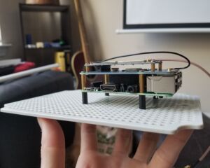 Raspberry Pi and the LoRaGo PORT Multi-channel LoRaWAN Gateway (Sandbox Electronics) being positioned on the back plate of the enclosure.