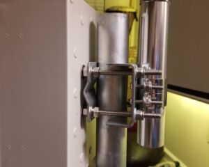 An antenna mast clamp to connect the outdoor enclosure and antenna to a 2-inch steel pole.