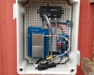 Completed gateway with Raspberry Pi, LoRaWAN gateway, power over ethernet (PoE) adapter, adjustable buck converter regulated at 5-volts, a SHT31 temperature and humidity sensor, and weatherproof ethernet cable gland to enable power and data transmission.